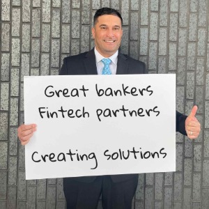 Smiling man holding sign and thumbs up